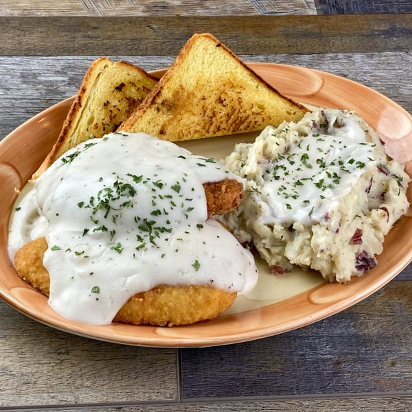 Lucky's chicken fried steak with gravy, mashed potatoes, and two slices of toast.